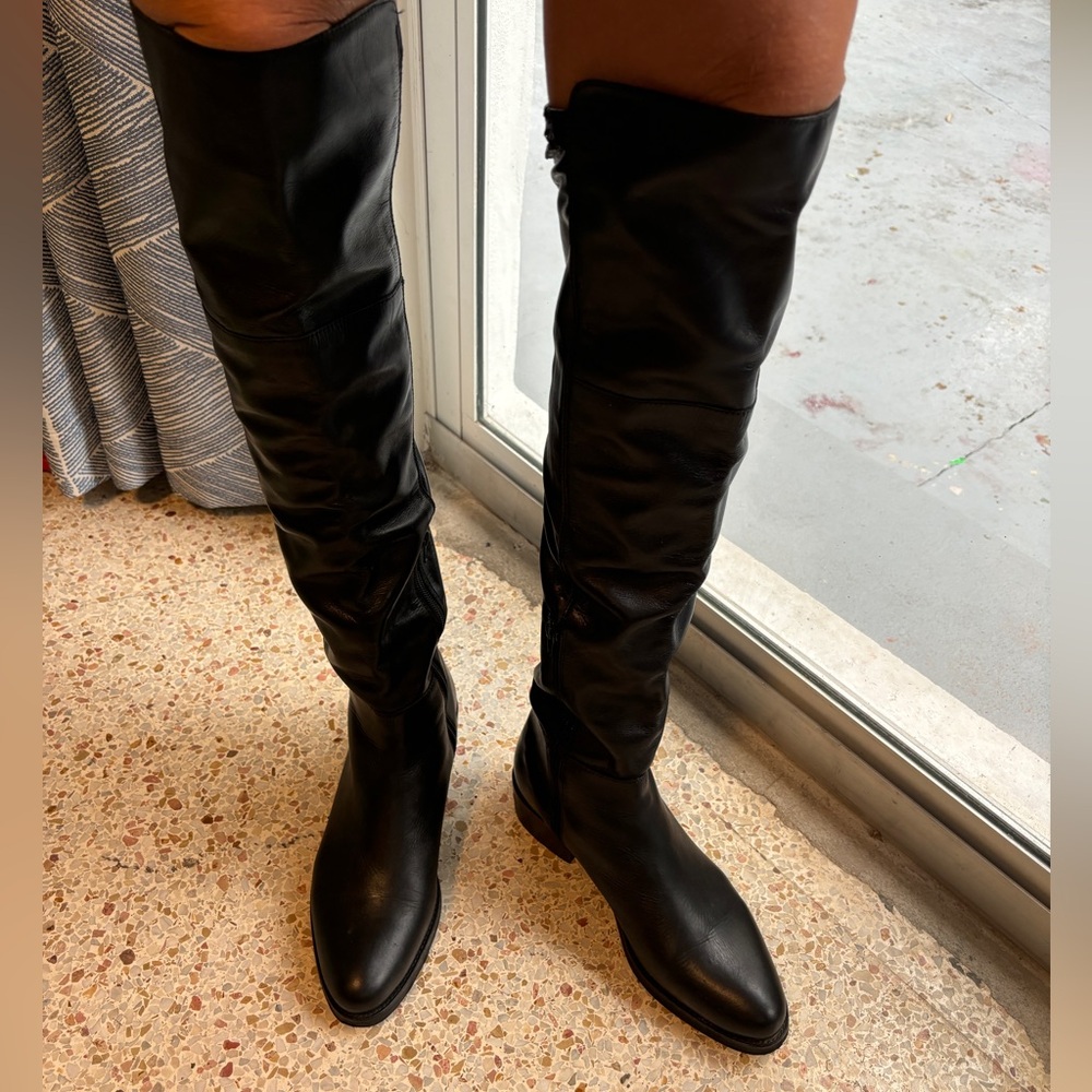 Black leather knee high boots on a little heel